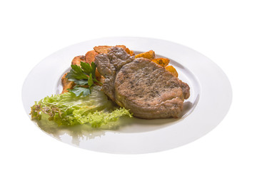 pork chops with potatoes on a white plate