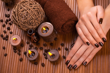 beautiful brown manicure on a bamboo background