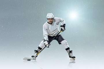 Fototapeta na wymiar Ice hockey player on the ice and light effects