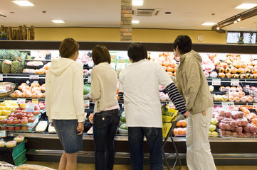 young men doing some shopping in supermarket