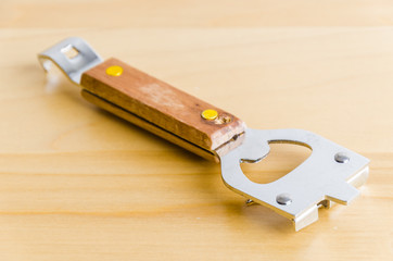 Can opener on wood background