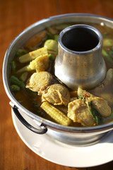 spicy yellow fish soup in sunlight