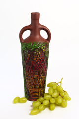 clay bottle and grapes