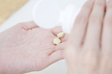 hand of woman holding supplement
