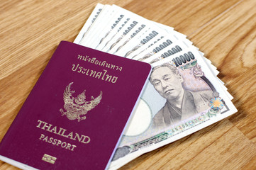 Fototapeta premium Japanese banknotes and Thailand passport