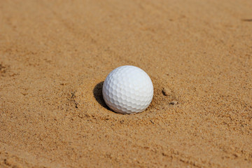 Golf ball  on sand in bunker