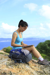 Fototapeta na wymiar woman hiker use digital tablet seaside