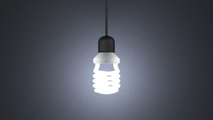 Glowing spiral light bulb hanging on gray