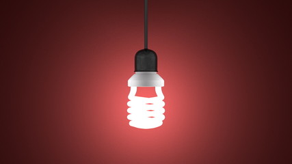 Glowing spiral light bulb hanging on red