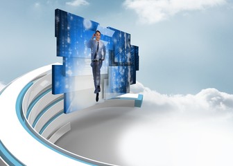 Composite image of businessman in data center on abstract screen