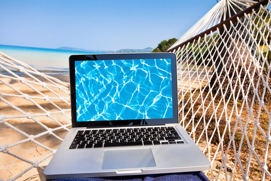 laptop in hammock on the beach