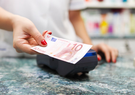 Paying For Medicine Using Cash At Pharmacy