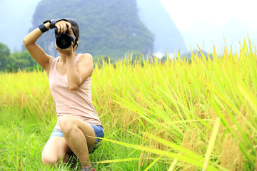 young woman photographer in rice field,yangshuo,china