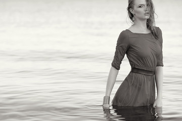 Fashion portrait of a young model with wet long ginger curly hai