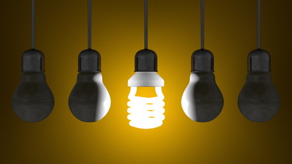 Glowing spiral light bulb, dead tungsten ones hanging on yellow