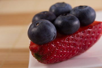 huckleberries on a piece of strawberry
