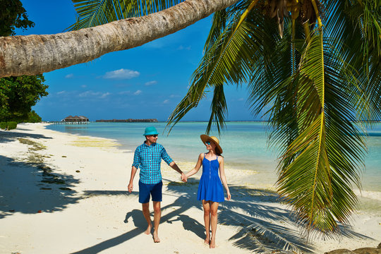 Couple in blue clothes on a beach at Maldives