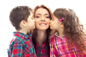 Happy mother kissed by her daughter and son
