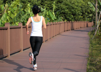 Fototapeta na wymiar woman running on wooden deck 