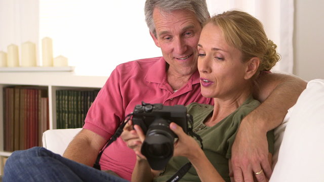 Mature couple looking at pictures on camera