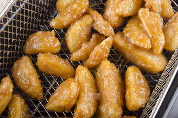 warm potato wedges in a sieve