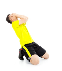Upset  or excited soccer player kneeling down