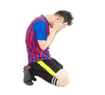 flushed football player kneeling down