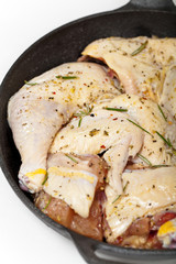 Raw chicken meat with rosemary and lemon ready to bake