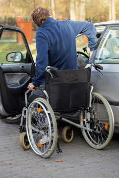 Disabled man getting in the car