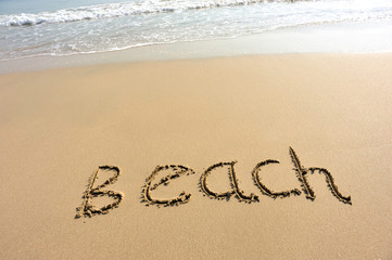 Fototapeta na wymiar beach word drawn on beach