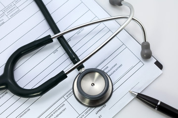 pen and stethoscope on blank Patient information