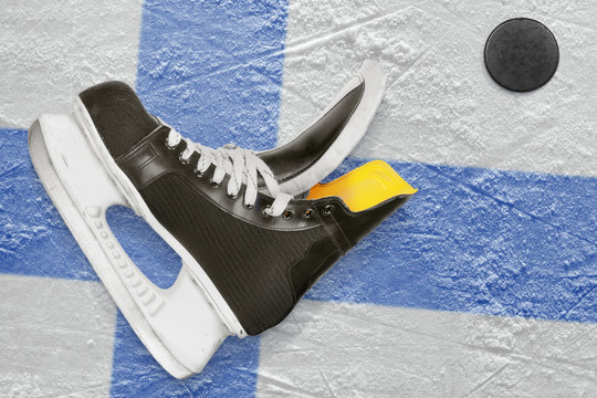 Puck, skates and Finnish flag