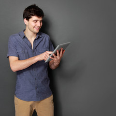 young male smiling using digital tablet