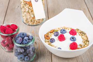 Fresh yoghurt with home made cereals and muesli, fresh raspberry