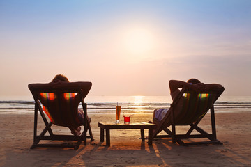 happy couple enjoy sunset on the beach