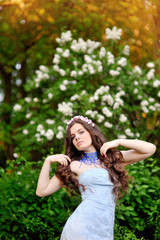 Obraz premium beautiful girl on a background of white flowering trees