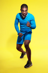 Fototapeta na wymiar Athletic black man in sportswear fashion. Runner. Intense colors