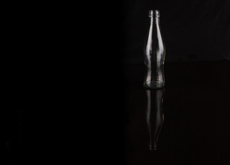 Empty bottles over black background