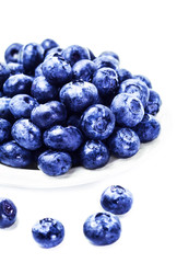 Fresh Blueberries on white plate isolated on white background cl