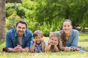 Portrait of parents and kids lying at park