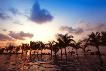 beautiful swimming pool near the beach by sunset