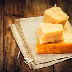 Parmesan Cheese on Wooden Background close up. Piece of Parmesan