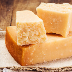 Gourmet Parmesan Cheese on Wooden Background close up. Piece of