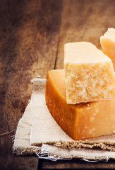Gourmet Parmesan Cheese on Wooden Background close up. Piece of
