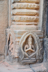 Ancient Khmer carving showing merit  praying at the Hindu temple