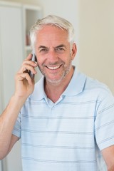 Smiling man on a phone call looking at camera
