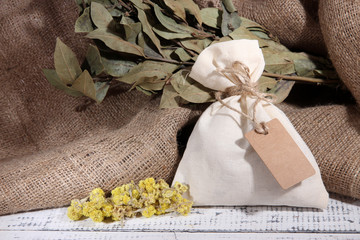 Textile sachet pouch with dried flowers