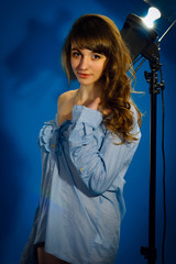 pretty girl posing in studio on a blue background