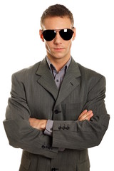 Young businessman in sunglasses at a suit