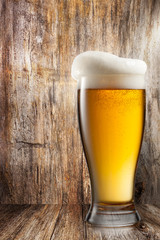 Glass of beer on wooden background